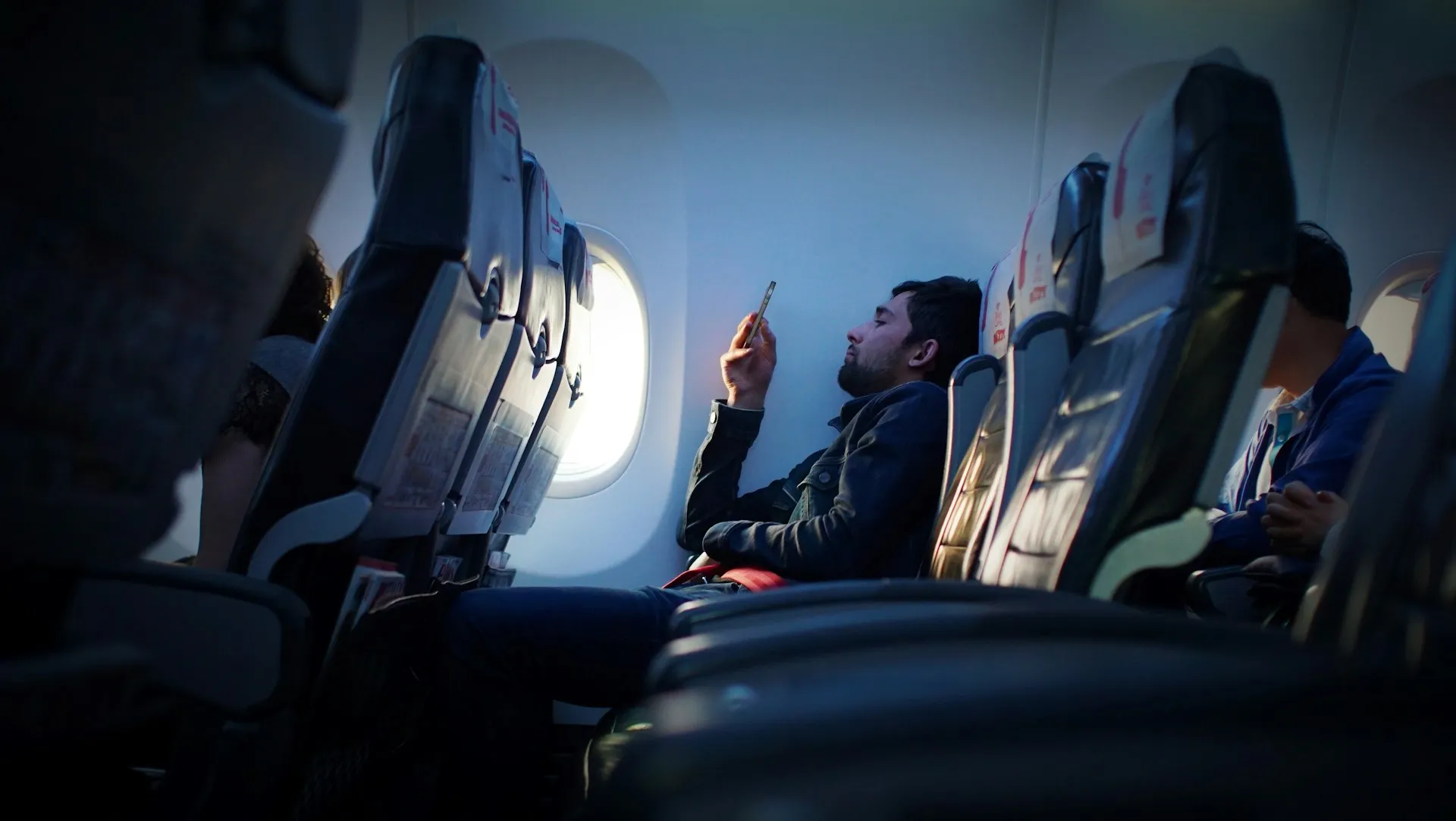 Person using a smartphone on an airplane