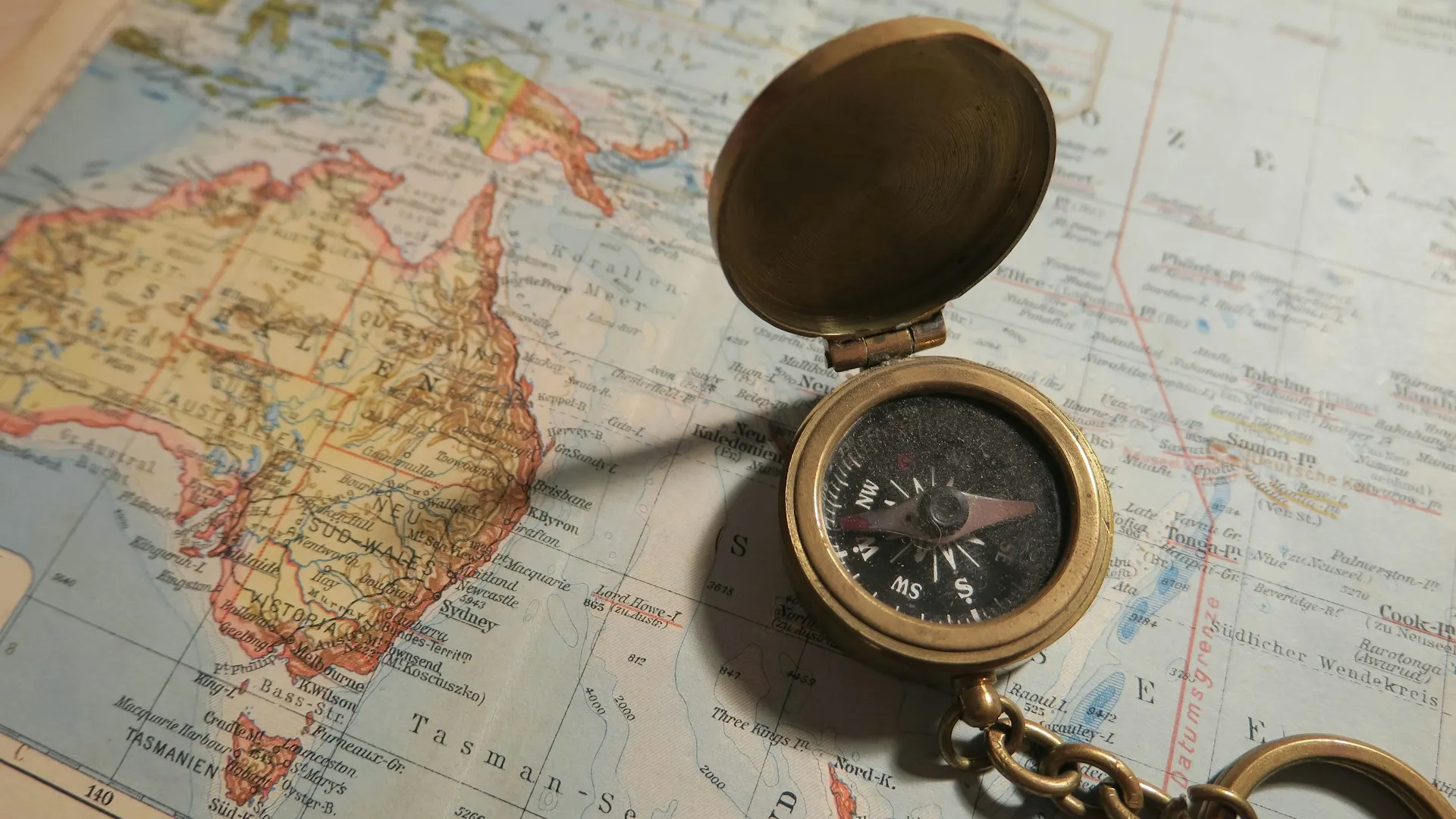 Navigation compass on a printed world map