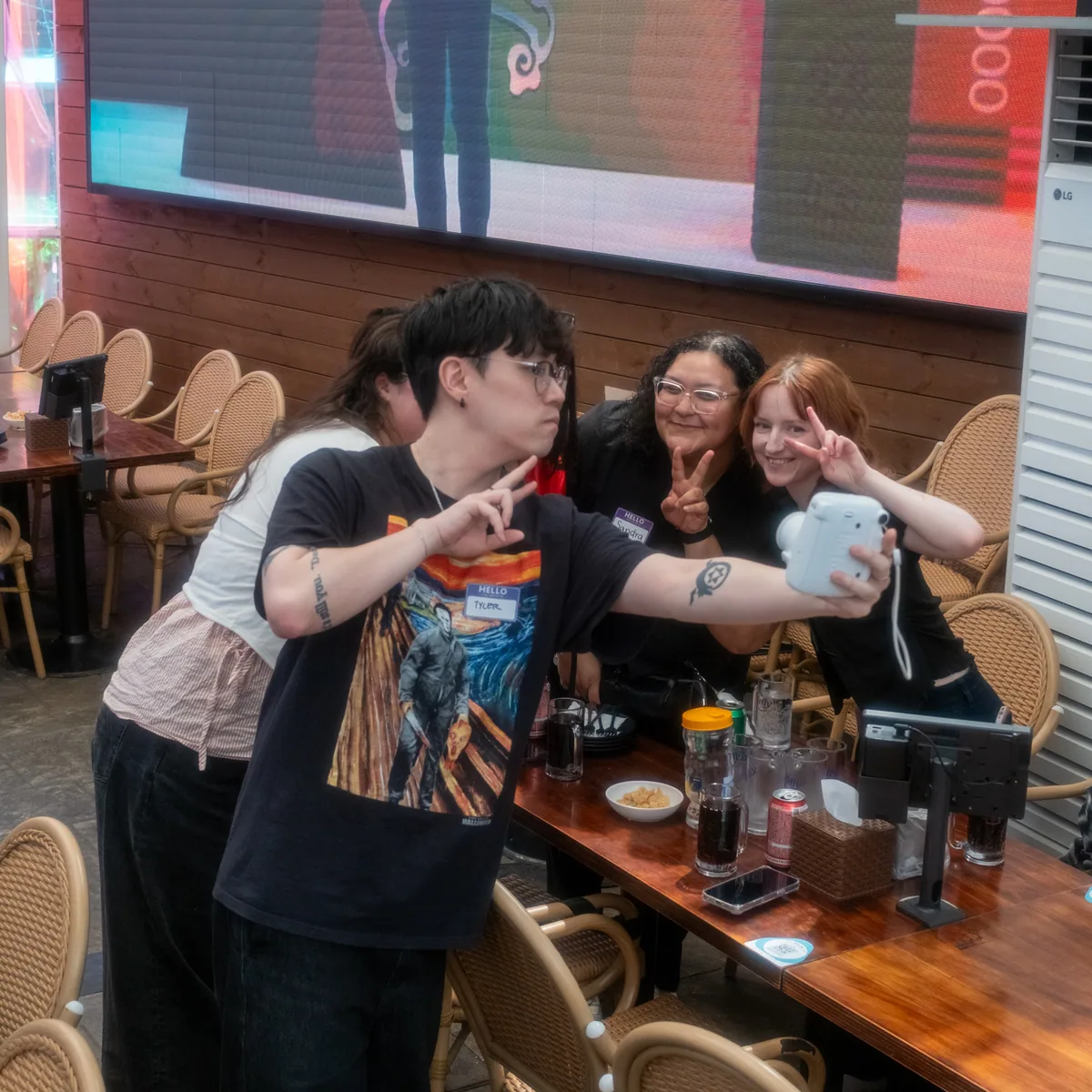 Group of four ESL teachers taking a Polaroid selfie at the Korvia Spring Party 2026 photo booth in Itaewon