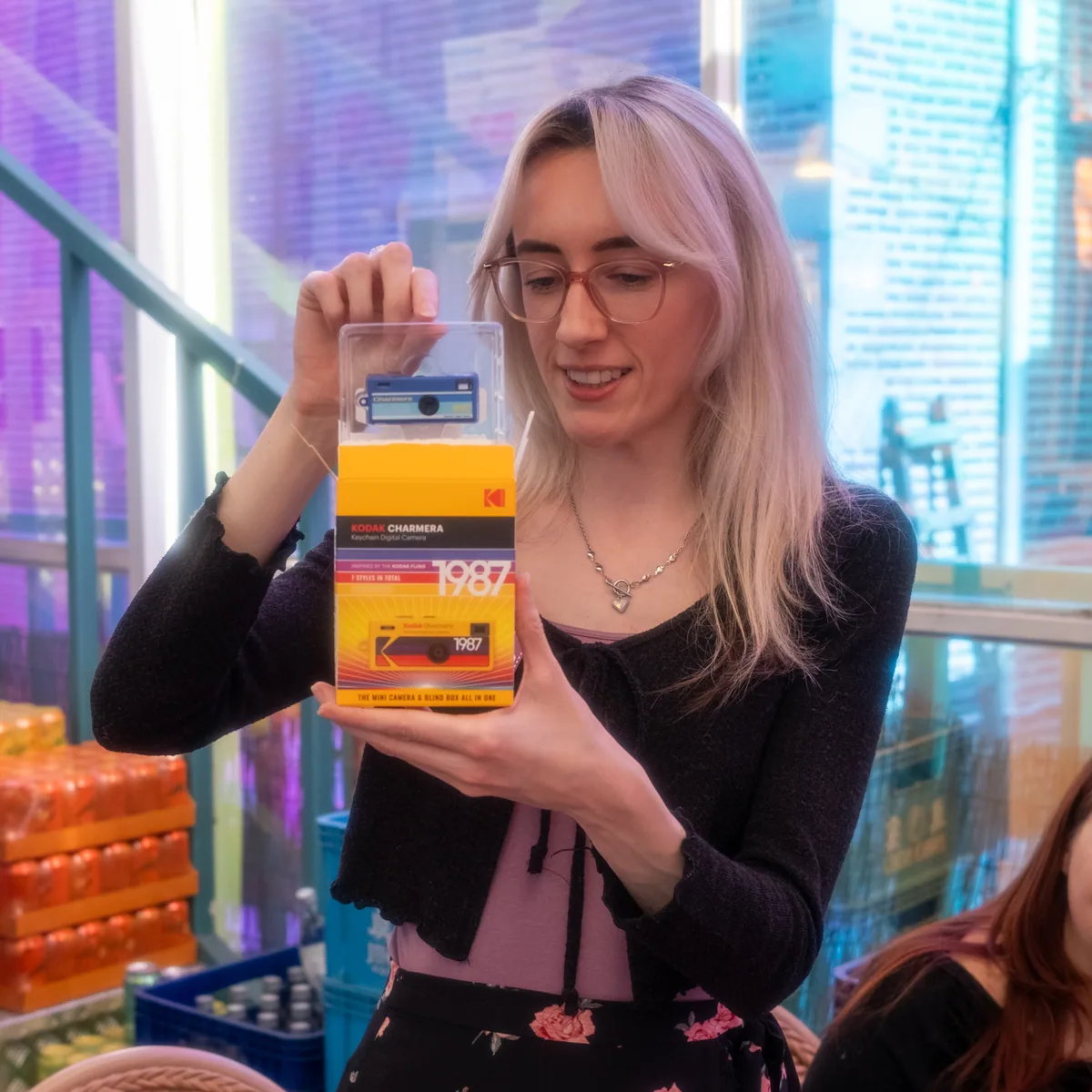 Smiling raffle winner holding a Kodak Charmera 1987 retro camera at the Korvia Spring Party 2026